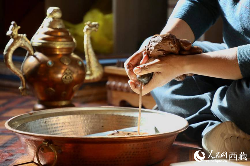 牛角鉆孔，將木泥擠出。人民網(wǎng)記者 次仁羅布攝