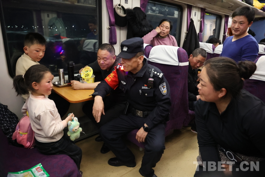 乘警長左紅彬在巡視車廂間隙，向攜帶兒童的旅客專門叮囑安全注意事項(xiàng)。.JPG