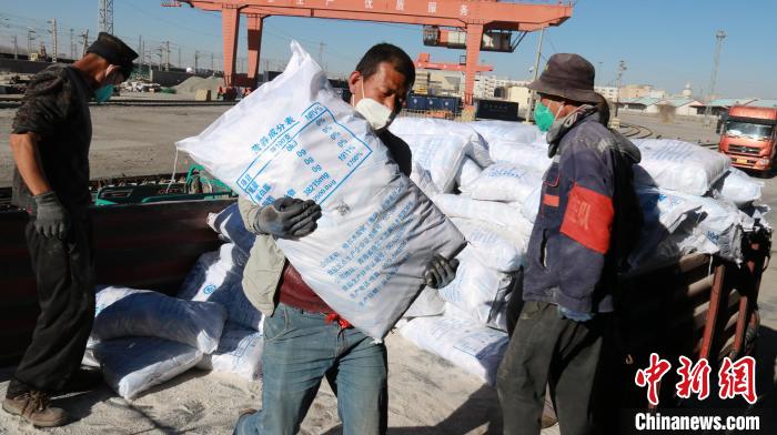 圖為裝卸人員將食鹽從汽車倒裝到火車上?！±钌?攝