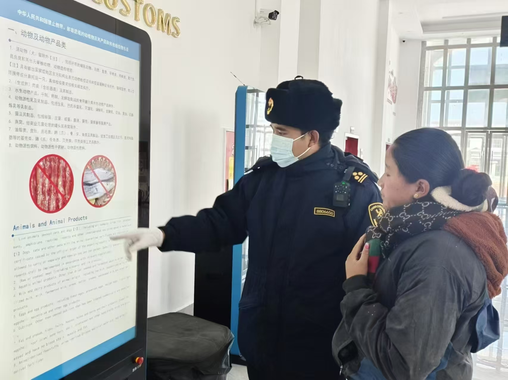 海關(guān)關(guān)員對(duì)入境邊民進(jìn)行禁止攜帶、郵寄進(jìn)境動(dòng)植物及其產(chǎn)品解讀。次旺久美攝